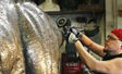 Metal polishing on dinosaurs for Fernbank  Natural History museum Atlanta, GA front plaza fountain project