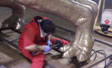 Polishing bronze coating on mother dinosaur for Fernbank  Natural History museum Atlanta, GA front plaza fountain project.